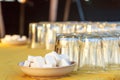 Two plates containing sugar cubes and several upside down glasses on a table Royalty Free Stock Photo