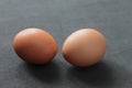 Closeup of two raw eggs on a gray table Royalty Free Stock Photo