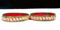Closeup of two red and green bracelets decorated with small stones on a white surface Royalty Free Stock Photo