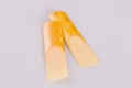 Closeup two reeds for saxophone lying on white surface Royalty Free Stock Photo