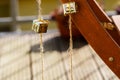 Closeup of two small presents, wrapped in shiny golden gift wrap paper, hanging on vertical cord