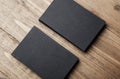 Closeup of two stack Of blank black business cards on wooden background