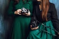 Closeup of two women`s holding vintage film cameras in studio Royalty Free Stock Photo