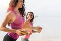 Closeup Of Two Young Woman Jogging On Beach Together Attractive Girls Running On Seaside Sport Runner Fitness Training Royalty Free Stock Photo