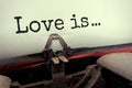 Closeup typed text Love is written on sheet of paper in a mechanical typewriter Royalty Free Stock Photo