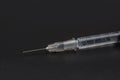 Closeup U-100 Insulin syringe on black background. Use as Medicine, diabetes, glycemia, health care and people concept