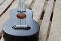 Closeup ukulele on a wooden floor. Royalty Free Stock Photo