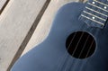 Closeup ukulele on a wooden floor. Royalty Free Stock Photo