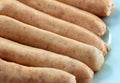 Closeup of uncooked chipolata sausages.