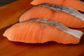 Closeup uncooked sliced salmons on a chopping board