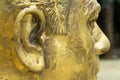 Closeup of unfinished bronze head.