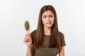 Closeup unhappy frustrated young woman surprised she is losing hair, noticed split ends receding hairline. Gray Royalty Free Stock Photo