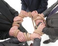 Closeup.unified business team ,tied a strong rope. Royalty Free Stock Photo