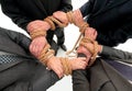 Closeup.unified business team ,tied a strong rope. Royalty Free Stock Photo