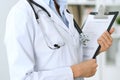 Closeup of unknown doctor woman standing with medication history records form at hospital. Health care, insurance an