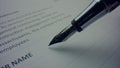 Unknown person signing document with pen. Worker using nibbed fountain pen Royalty Free Stock Photo