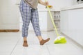 Unknown woman cleaning floors with a broom