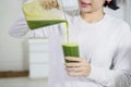 Unknown woman pouring healthy juice
