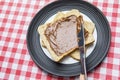 Unknown woman spreading chocolate cream on bread