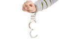 Closeup of unlocked handcuffs hanging on man hand