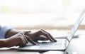 Closeup of unrecognizable black female working on laptop, typing on computer keyboard Royalty Free Stock Photo