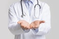 Closeup of unrecognizable doctor holding invisible object on his open palms