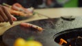 Friends preparing food for bbq party outside. Guys putting shrimp on grill