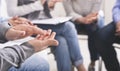 Closeup of unrecognizable male hands applauding at group therapy session