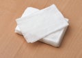 Stack of unwrapped wet wipes on wooden table Royalty Free Stock Photo