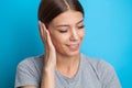 Closeup up side profile sick female having ear pain touching her painful head Royalty Free Stock Photo