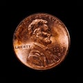 Closeup of a 1 US dollar cent from 2015 also called penny isolated on a black background Royalty Free Stock Photo