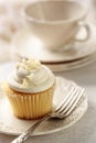 Closeup of vanilla cupcake with tea cup Royalty Free Stock Photo