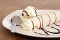 Closeup vanilla ice cream crepe with chocolate sauce and spoon Royalty Free Stock Photo