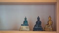 Variety small buddha statue on buddha shelf at Thailand home Royalty Free Stock Photo