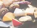 Closeup of various cheeses on wooden table with buns