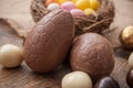 various chocolate easter eggs on wooden background