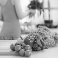 Closeup on vegetables on cutting board and housewife in ba Royalty Free Stock Photo