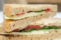 Closeup on a vegetarian sandwich with cheddar cheese, tomato, spinach with mango and apricot chutney in seeded malted bread