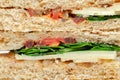 Closeup on a vegetarian sandwich with cheddar cheese, tomato, spinach with mango and apricot chutney in seeded malted bread