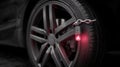 Closeup of a vehicle immobilization device securely attached to a tire highlighting advanced antitheft technology in Royalty Free Stock Photo