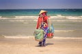 Closeup Vendor in Hat with Yoke Stands on Ocean Beach