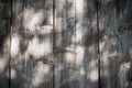 Closeup of vertical gray wooden fence panels with shadows. Vignetted. Texture or background Royalty Free Stock Photo
