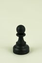 Closeup vertical shot of a chess single pawn piece isolated on a white background