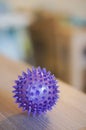 Closeup vertical shot of a purple spike ball on a wooden table