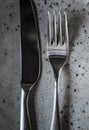 Closeup vertical shot of a silver table knife and a table fork Royalty Free Stock Photo