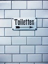 Closeup vertical shot of a toilet sign with a german writing Royalty Free Stock Photo