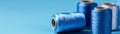 Closeup of vibrant blue thread spools on matching blue backdrop serene still life Royalty Free Stock Photo