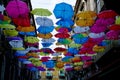 Closeup of a vibrant colorful umbrellas hanging in the street on a sunny day