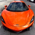 Closeup of a vibrant McLaren 540C parked on the side of the street