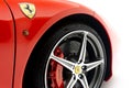 Closeup of a vibrant red Ferrari wheel isolated on white background Royalty Free Stock Photo
